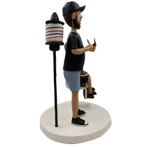 Bobblehead barbiere con bambino