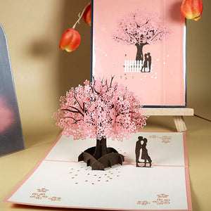Biglietto d'auguri pop-up 3D con coppia romantica sotto un ciliegio